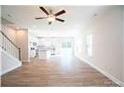 Sunlit living room featuring hardwood floors, a ceiling fan, and open concept layout to the kitchen at 620 Smith St # B, Mooresville, NC 28115