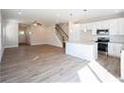 Inviting living space showcasing open layout, hardwood floors, and a modern kitchen with white cabinets at 620 Smith St # B, Mooresville, NC 28115
