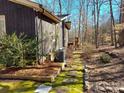 Home exterior featuring a stone pathway and lush green moss at 8015 Sullivan Dr # 3 And 2, Charlotte, NC 28215