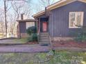 Inviting front entrance with a red door and manicured landscaping at 8015 Sullivan Dr # 3 And 2, Charlotte, NC 28215
