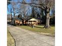 Classic brick ranch-style home with a long driveway, mature tree, and a well-maintained front lawn at 8628 Williamsburg Cir, Huntersville, NC 28078