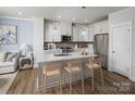 Modern kitchen with stainless steel appliances, kitchen island and wood floors at 9416 Munsing Dr # 151, Charlotte, NC 28269