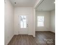 Bright foyer with wood-look flooring and a front door with glass panels at 955 General Hoke Dr, Lincolnton, NC 28092