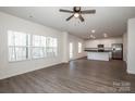 Open-concept living room flows into the kitchen with stainless steel appliances at 955 General Hoke Dr, Lincolnton, NC 28092