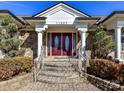 Inviting front entrance with stone accents and brick steps at 11027 Brief Rd, Charlotte, NC 28227