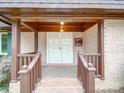 Inviting covered front porch with brick columns and a double door entrance at 1200 Berkshire Dr, Kannapolis, NC 28081