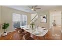 Bright dining room featuring modern decor, a stylish table, and a ceiling fan at 12724 Cliffcreek Dr, Huntersville, NC 28078