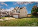The side view of this two-story home highlights the lawn and charming architectural details at 184 Settlers Grove Ln # L7, Salisbury, NC 28146