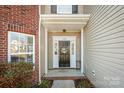 The inviting front entrance is framed by sidelights, manicured shrubs, and classic brick accents at 184 Settlers Grove Ln # L7, Salisbury, NC 28146