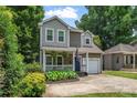 Charming two-story home with a covered porch, attached garage, and a well-manicured front yard at 1921 Kenilworth Ave, Charlotte, NC 28203