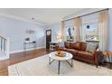 Cozy living room featuring a comfortable leather sofa and hardwood floors at 1921 Kenilworth Ave, Charlotte, NC 28203