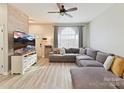 Comfortable living room showcasing a large sectional sofa, wood-look flooring, and natural light from large window at 1923 Gables Dr, Monroe, NC 28112