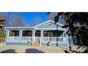 Inviting home featuring a cozy covered porch, white railings, and a charming facade at 2721 Dora Dr, Charlotte, NC 28215