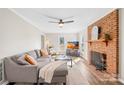 Inviting living room with brick fireplace, hardwood floors, and a comfortable sectional sofa at 2927 Forest Hills Cir, Rock Hill, SC 29732