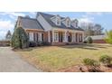 Charming brick home featuring a welcoming front porch with columns and dormer windows at 2968 Robinwood Rd, Gastonia, NC 28054