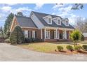 Charming brick home featuring a welcoming front porch with columns and dormer windows at 2968 Robinwood Rd, Gastonia, NC 28054