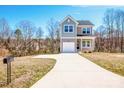 Inviting two-story home with a long driveway on a sunny day, showing curb appeal and outdoor space at 3220 5Th Street Ne Ct, Hickory, NC 28601