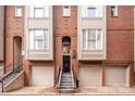 Elegant brick townhome with a private garage, stepped entryway, and traditional design elements at 351 W 7Th St, Charlotte, NC 28202