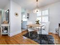 Bright dining area with stylish chandelier, table with four chairs, and hardwood floors at 4310 Randolph Rd, Charlotte, NC 28211