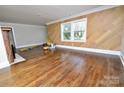 Spacious living room boasts hardwood floors, large window with a view and a unique fireplace at 506 E Ridge St, Kings Mountain, NC 28086