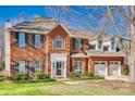 Beautiful two-story brick home with a well-maintained lawn and a two-car garage at 550 S Portman Ln, Fort Mill, SC 29708