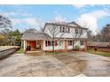 Charming two-story home with covered parking, and a well-kept lawn on a tree-filled lot at 623 Spring Sw St, Concord, NC 28025