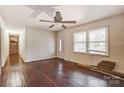 Inviting living room with shining wood floors, ceiling fan, and ample natural light from the front windows at 623 Spring Sw St, Concord, NC 28025
