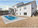 A serene backyard featuring a sparkling pool, complemented by a screened porch at 7206 Sumters Camp Trl, Fort Mill, SC 29707