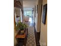 Inviting hallway featuring hardwood floors and stylish decor at 9709 Emerald Point Dr # 2, Charlotte, NC 28278