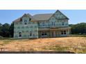 New construction home exterior featuring wrapped walls, windows, and architectural roofing at 11016 Tyler Brook Ln # Oak0036, Mint Hill, NC 28227