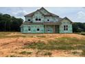 New home under construction with visible house wrap and framing, ready for customization at 11020 Tyler Brook Ln # Oak0035, Mint Hill, NC 28227