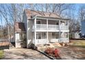 Charming two-story home featuring double balconies, a well-maintained yard, and inviting curb appeal at 11121 Timber Hill Ct, Charlotte, NC 28226