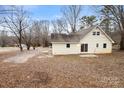 Spacious backyard featuring a well-maintained lawn and mature trees, offering privacy and tranquility at 1275 Rocky Creek Rd, Shelby, NC 28152