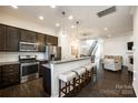 Stylish kitchen featuring stainless steel appliances and a breakfast bar with seating at 13319 Jacks Ln, Pineville, NC 28134