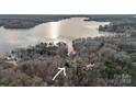 Aerial view showcasing the property's proximity to a large lake surrounded by lush trees at 1665 Sherwood Ct, Sherrills Ford, NC 28673