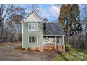 Attractive two-story house with a covered porch, complemented by mature trees and landscaping at 1665 Sherwood Ct, Sherrills Ford, NC 28673