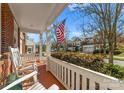 Inviting front porch with rocking chairs, showcasing neighborhood charm and an American flag at 18409 Harborside Dr, Cornelius, NC 28031