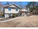 Attractive two-story home with well-maintained landscaping, a walkway, and a welcoming front entrance at 19320 Davidson Concord Rd, Davidson, NC 28036