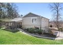 A beautifully landscaped backyard showcases a screened porch and a paved driveway at 19320 Davidson Concord Rd, Davidson, NC 28036