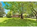 This traditional home has a spacious front lawn shaded by mature trees in a lush yard at 2041 Jefferson Ave, Gastonia, NC 28056