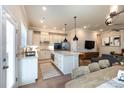 Open kitchen with stainless steel appliances, quartz countertops, and hardwood floors at 2551 Barry St, Charlotte, NC 28205