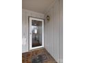 Well lit front door featuring wood trim and brick flooring, creating a warm entrance at 281 S Herlong Ave # Apt E, Rock Hill, SC 29732