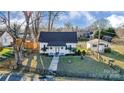 Charming home with fenced yard, mature trees, and inviting curb appeal at 305 S Clay St, Gastonia, NC 28052