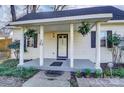 Inviting front porch with classic columns, hanging plants and welcoming details at 305 S Clay St, Gastonia, NC 28052