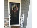 Inviting front door with a welcoming wreath and a 'Welcome friends' sign at 3403 Laurel Oak Ln, Gastonia, NC 28056