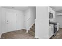 Inviting entryway features a staircase, white walls, and vinyl floors at 3708 13Th Ne St, Hickory, NC 28601