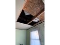 Interior shot of a damaged ceiling and light green walls ready for renovation and repair at 424 Chambers St, Statesville, NC 28677