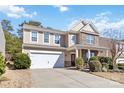 Charming two-story home with a well-manicured lawn and attached two-car garage at 4462 Haddington Dr, Fort Mill, SC 29707