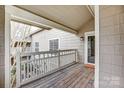 Inviting covered balcony with wood flooring and white railing, great for outdoor enjoyment at 5011 Sharon Rd # B, Charlotte, NC 28210