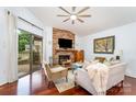 Cozy living room with vaulted ceiling, stone fireplace, and sliding door leading to the deck at 5011 Sharon Rd # B, Charlotte, NC 28210